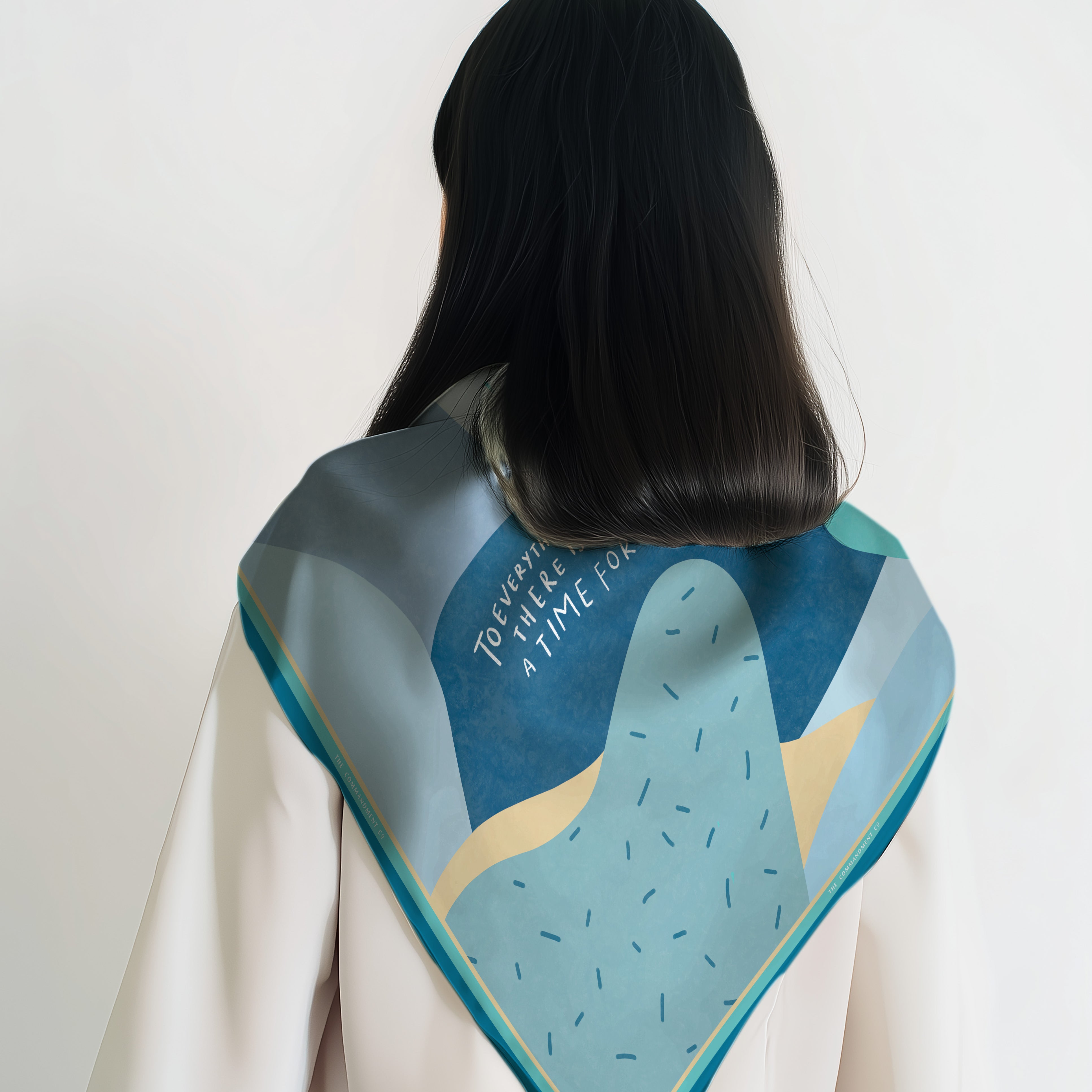 Back view of a model wearing a colorful abstract scarf featuring Ecclesiastes 3:1 “To everything there is a season” in a modern Christian design by The Commandment Co.