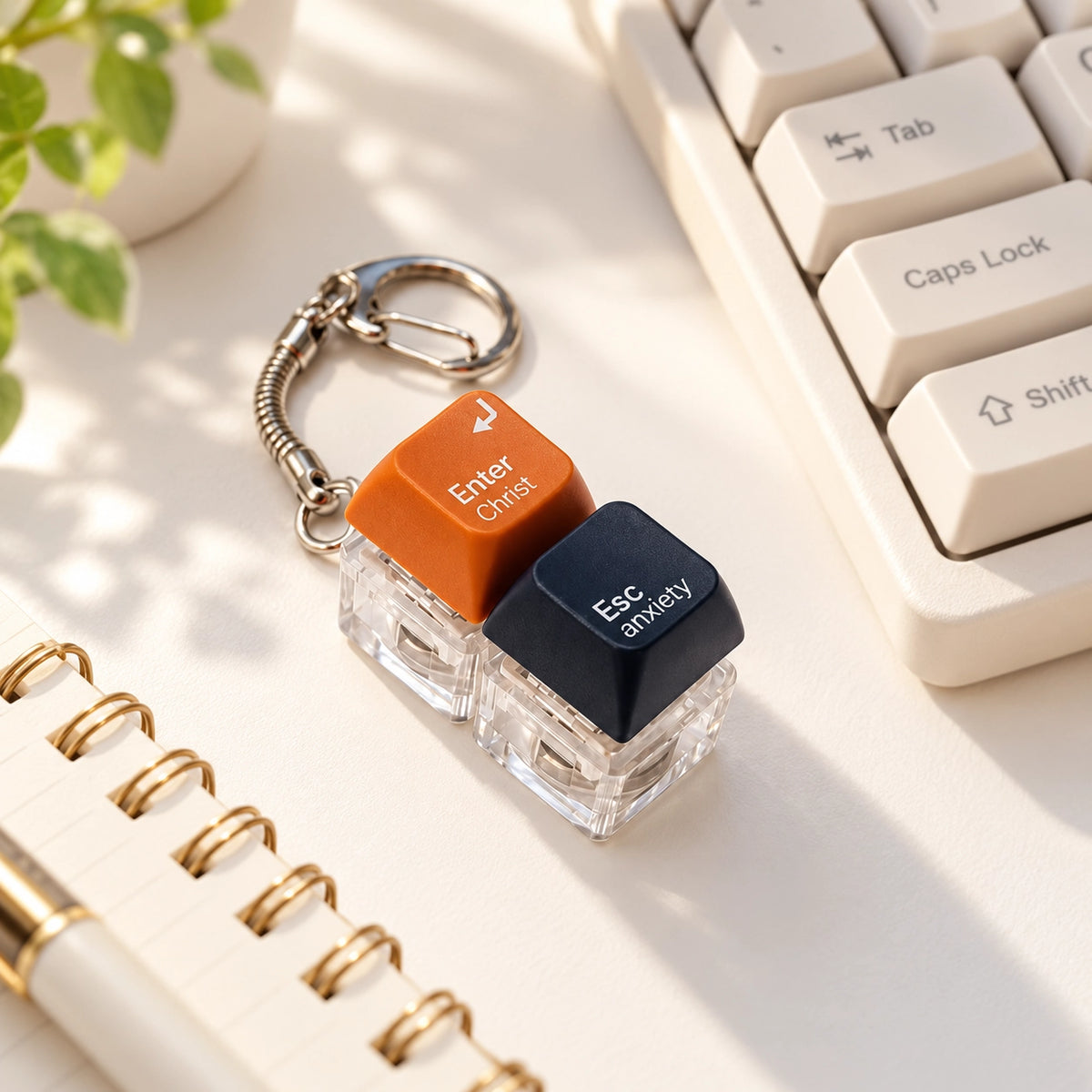 Enter Christ Escape Anxiety light-up keycap keychain styled beside a keyboard and notebook in warm natural light