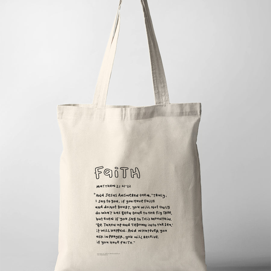 Faith Bible verse tote bag featuring Matthew 21:21-22 in a handwritten typography design on a natural canvas tote.