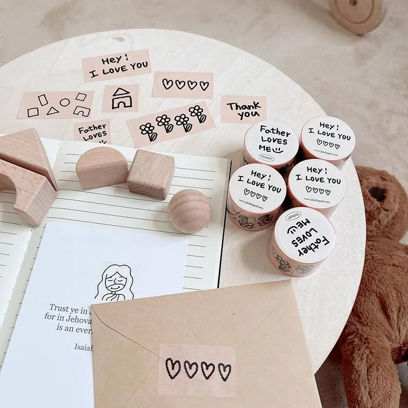 Father Loves Me Christian washi tape with hand-drawn hearts, flowers, house illustrations and encouraging phrases displayed on a wall