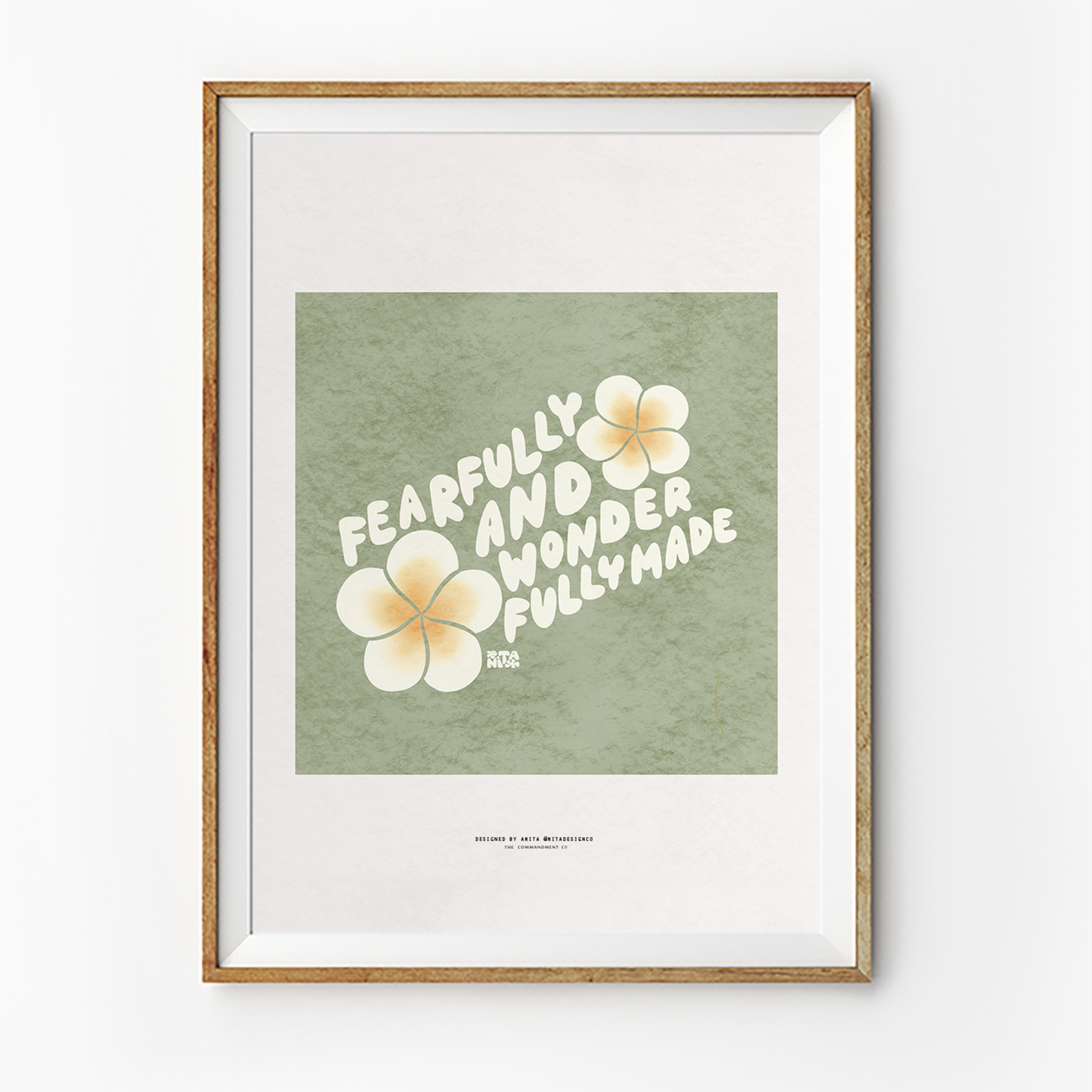 Encouraging "Fearfully and wonderfully made" poster in a wooden frame, featuring bold white lettering and soft yellow flowers on a green background, celebrating Christian identity and simple happiness.