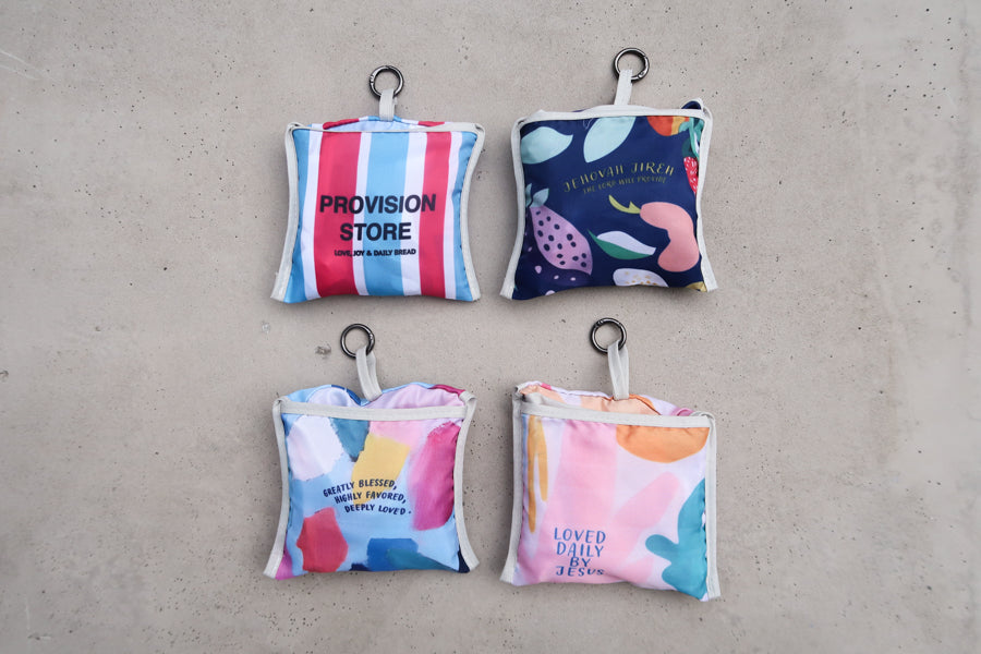 Four foldable reusable
Bible verse shopping bags
in compact pouches,
featuring uplifting designs,
ideal for Christian gifts
from a Christian gift store.