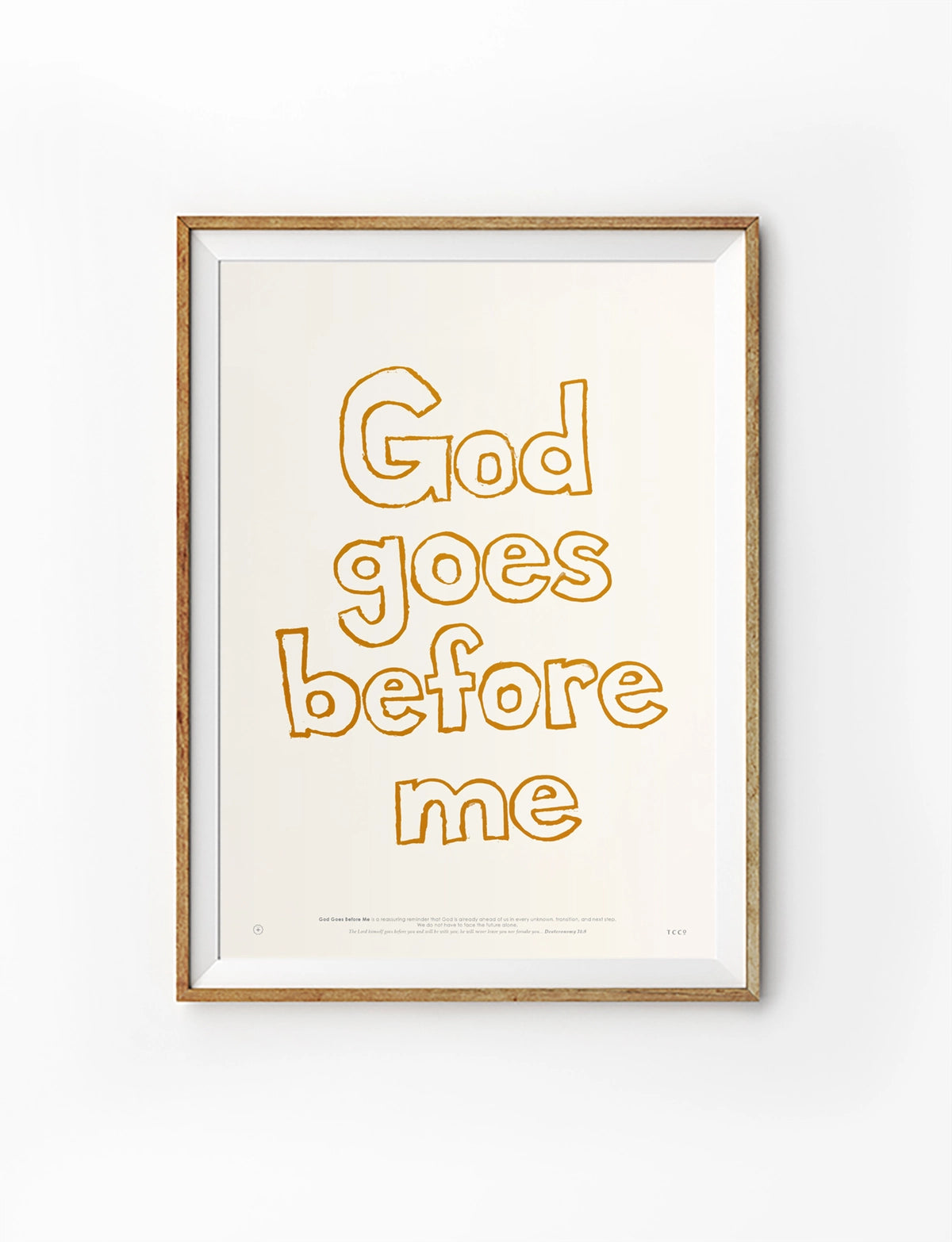 God Goes Before Me Christian poster with warm outlined typography in a wooden frame