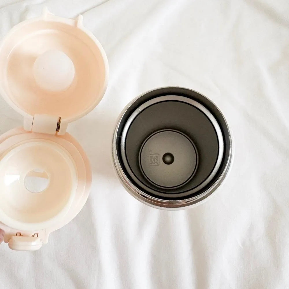 Interior view of the God Is a Good Father thermal bottle showing its smooth stainless steel inner lining