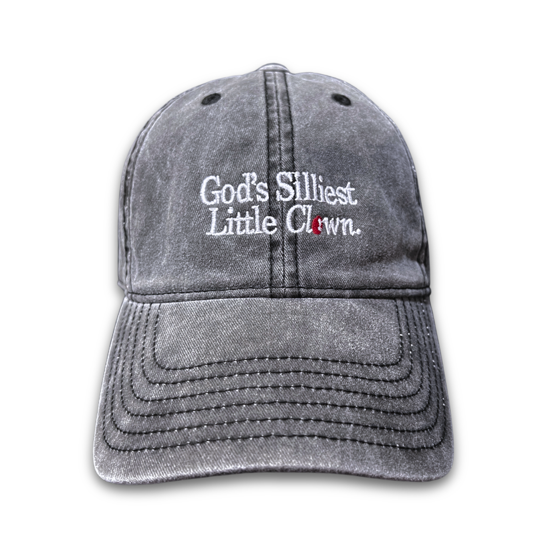 God’s Silliest Little Clown embroidered washed-grey cotton cap by Quite at Home.