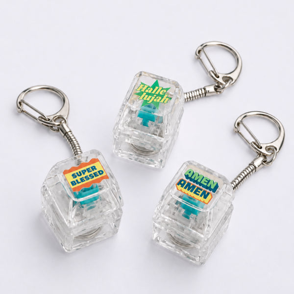 Hallelujah, Super Blessed and Amen Amen light-up keycap keychains arranged on a white background