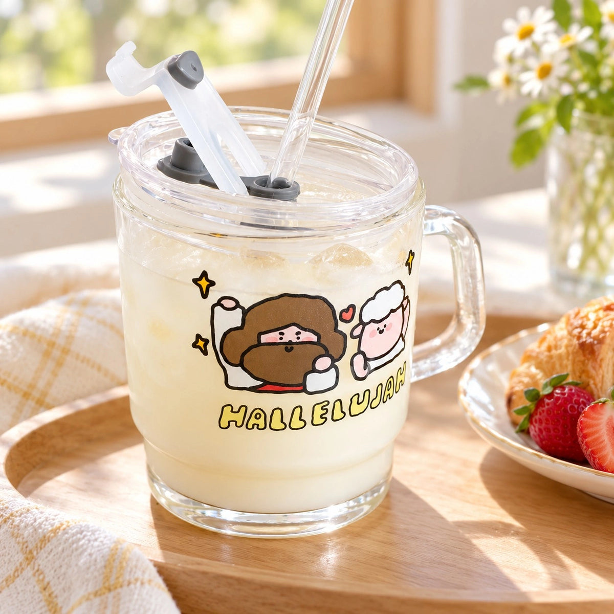 Hallelujah glass tumbler with straw filled with an iced drink in a bright breakfast setting.