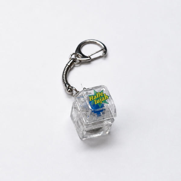 Hallelujah light-up keycap keychain with a transparent keycap and silver clasp on a white background