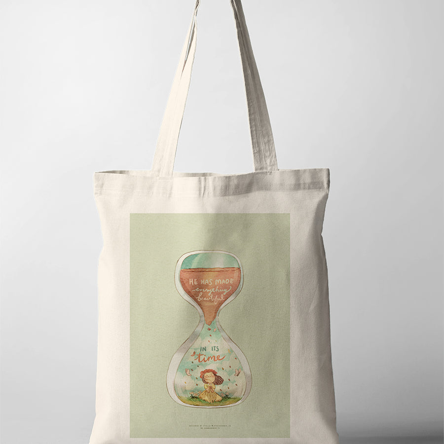 Christian tote bag with illustrated hourglass and the verse “He has made everything beautiful in its time” from Ecclesiastes 3:11