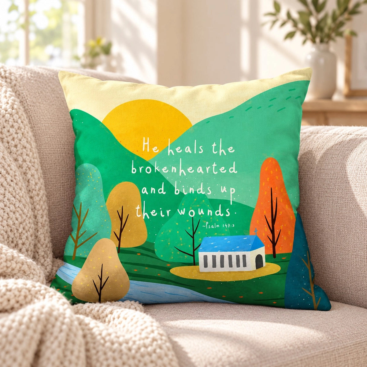 He Heals the Brokenhearted Psalm 147:3 colourful Christian cushion cover on a neutral sofa with a cream knitted throw.