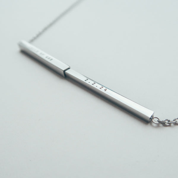 J&Co Foundry hidden-message bar necklace in a personalised jewellery display.
