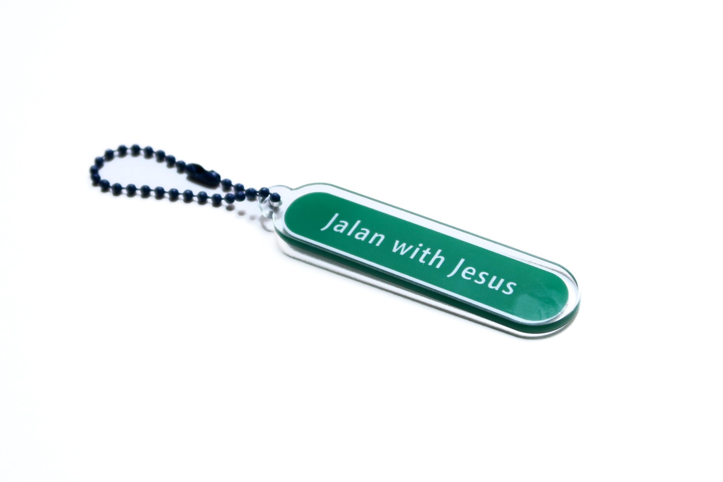 Acrylic keychain designed like a street sign with "Jalan with Jesus," from The Commandment Co, Singapore.
