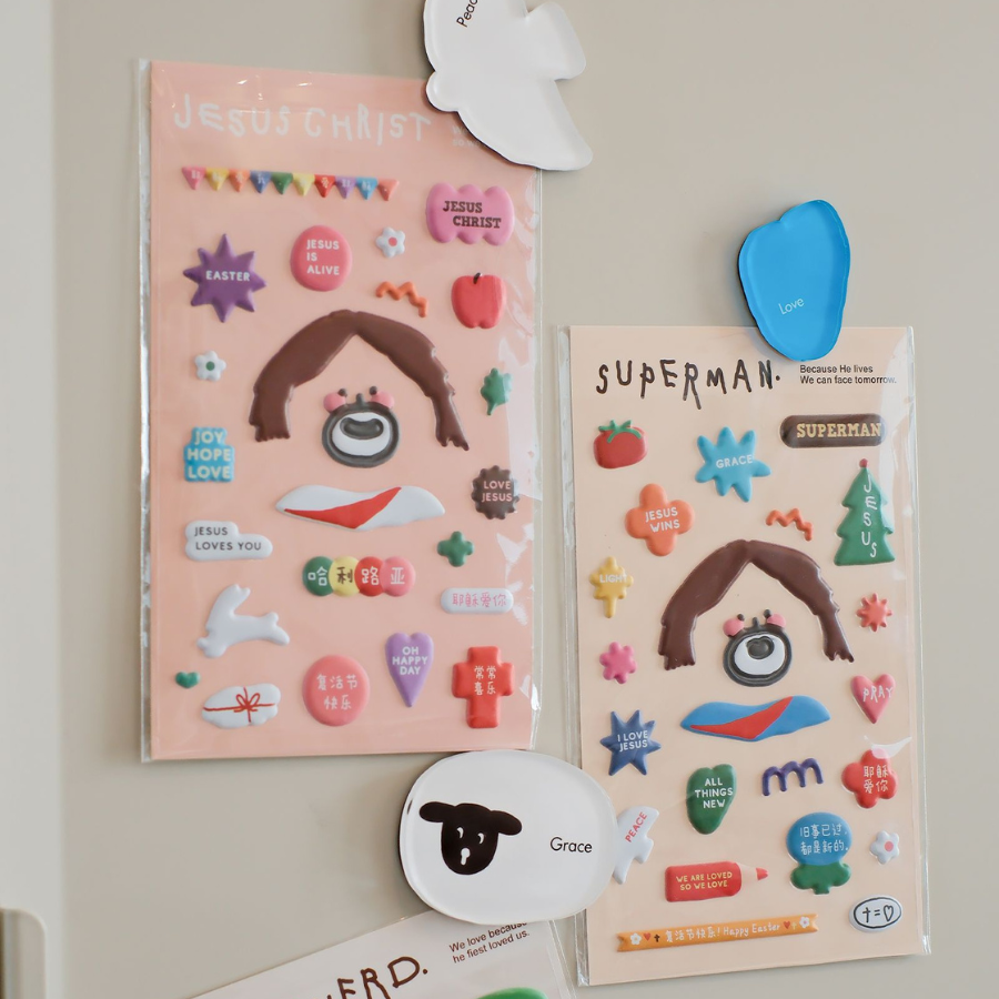 Soft Jesus sticker sheets with designs of Jesus Christ, Superman, and Shepherd, featuring colorful and inspirational elements.