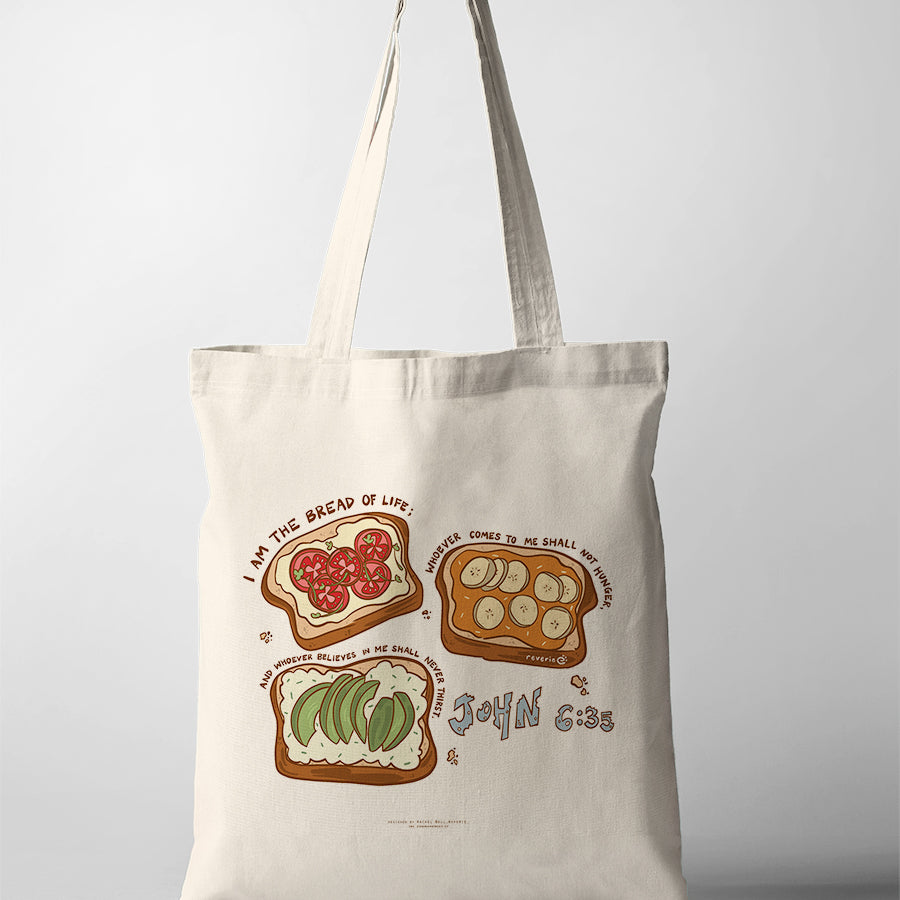 Canvas Christian tote bag with illustrated bread and toppings design featuring the verse “I am the bread of life” from John 6:35
