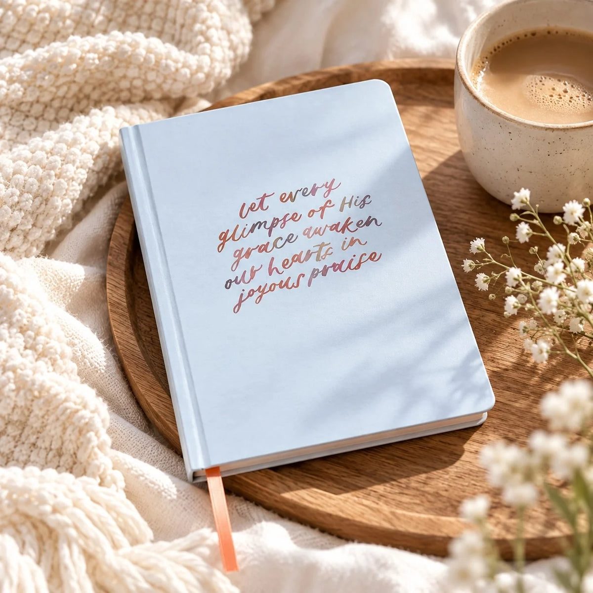 Joyous Praise Christian hardcover journal in light blue with inspirational lettering, styled beside coffee on a wooden tray