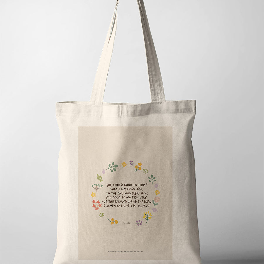 Christian tote bag featuring Lamentations 3:25-26 with floral artwork and a reminder to wait quietly for the Lord