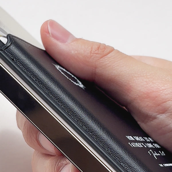 Close-up of premium full-grain leather texture and precise stitching on the Leather MagSafe Wallet
