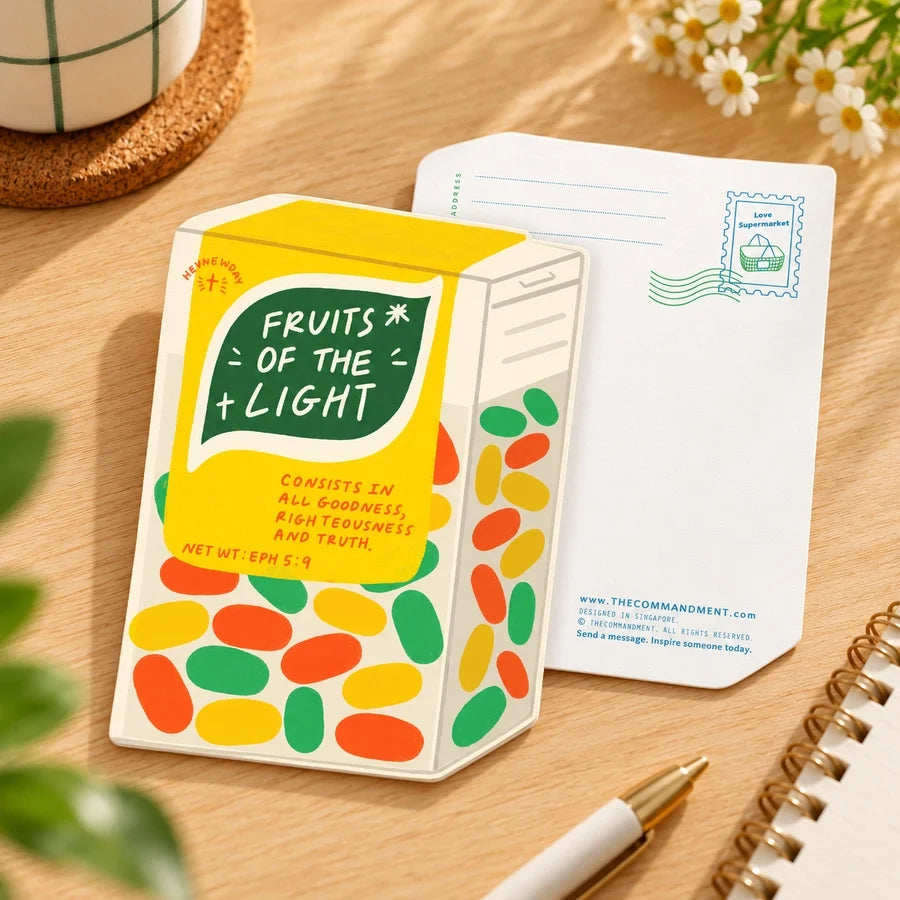 Light Fruity Mints LOVE SUPERMARKET shaped card photographed on a warm wooden desk with its postcard back