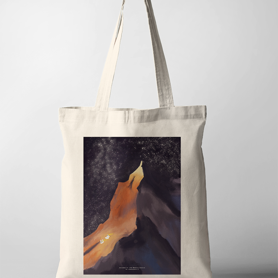 Light in the Darkness tote bag featuring a mountain and starry night design, Christian inspirational accessory from The Commandment Co, Singapore