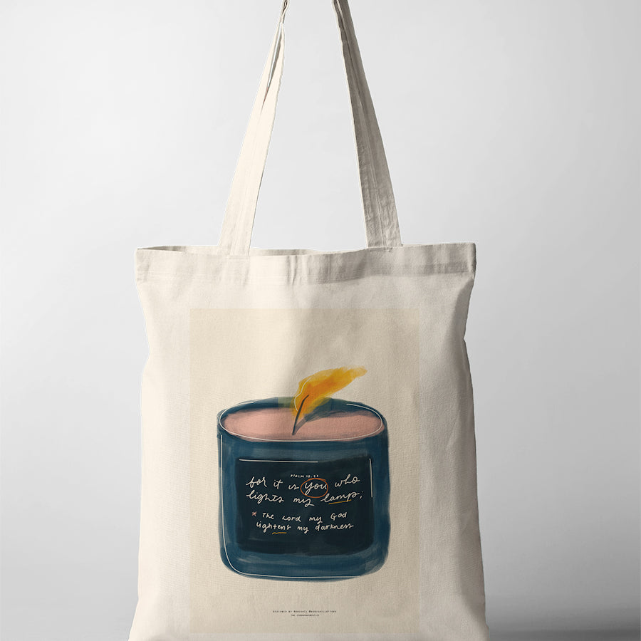 Christian tote bag featuring a candle illustration with Psalm 18:28, “You light my lamp”