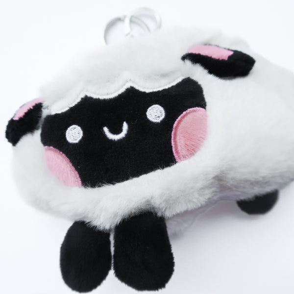 Three faith-inspired Lil Sheepies plush keychains in White Cumulus, Pink Hana, and Stormy Gray are displayed on a white background. Each soft, fluffy sheep represents a reminder of the Good Shepherd’s love, featuring a Bible verse charm, a retractable string for easy card access, and a secure keychain clip. Perfect as a Christian gift or daily faith companion.