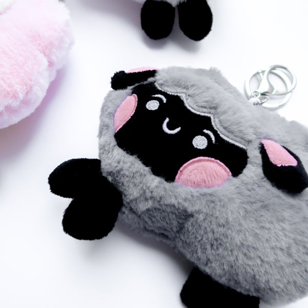 Three faith-inspired Lil Sheepies plush keychains in White Cumulus, Pink Hana, and Stormy Gray are displayed on a white background. Each soft, fluffy sheep represents a reminder of the Good Shepherd’s love, featuring a Bible verse charm, a retractable string for easy card access, and a secure keychain clip. Perfect as a Christian gift or daily faith companion.