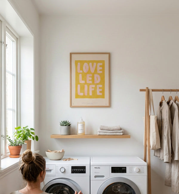 Love Led Life Scripture poster displayed in a bright neutral laundry room