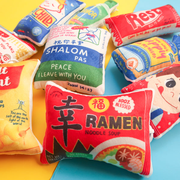 Love Supermarket plushie keychain collection featuring Blessed Ramen, Salt & Light, Shalom Pas, Beloved, and other faith-inspired snack designs.