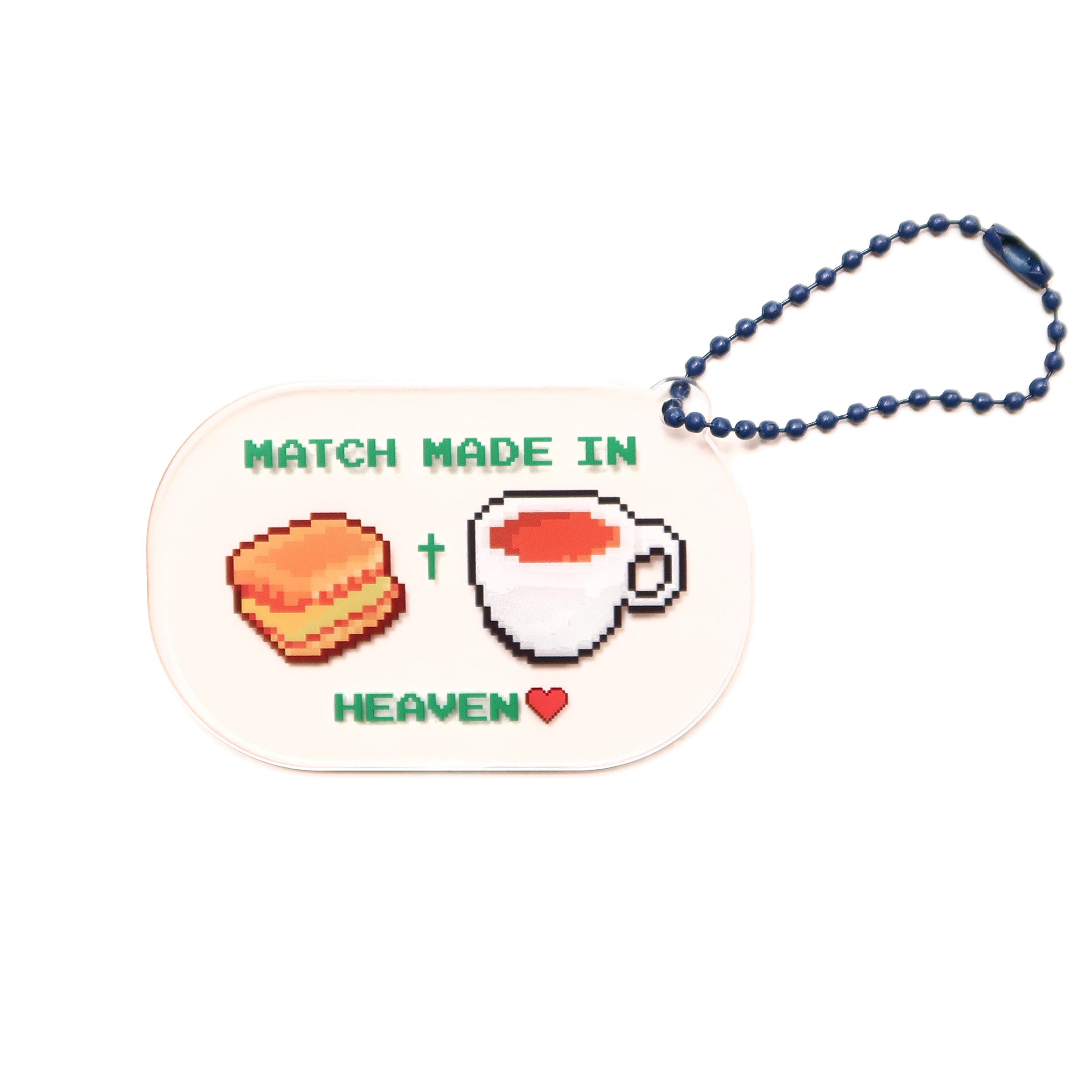Acrylic keychain with "Match Made in Heaven" design featuring a biscuit and a cup of tea, from The Commandment Co, Singapore.