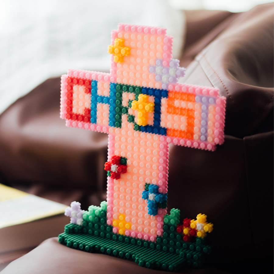 Colorful micro-brick Christian cross with “CHRIST” lettering and flower accents, faith-inspired DIY decor by The Commandment Co