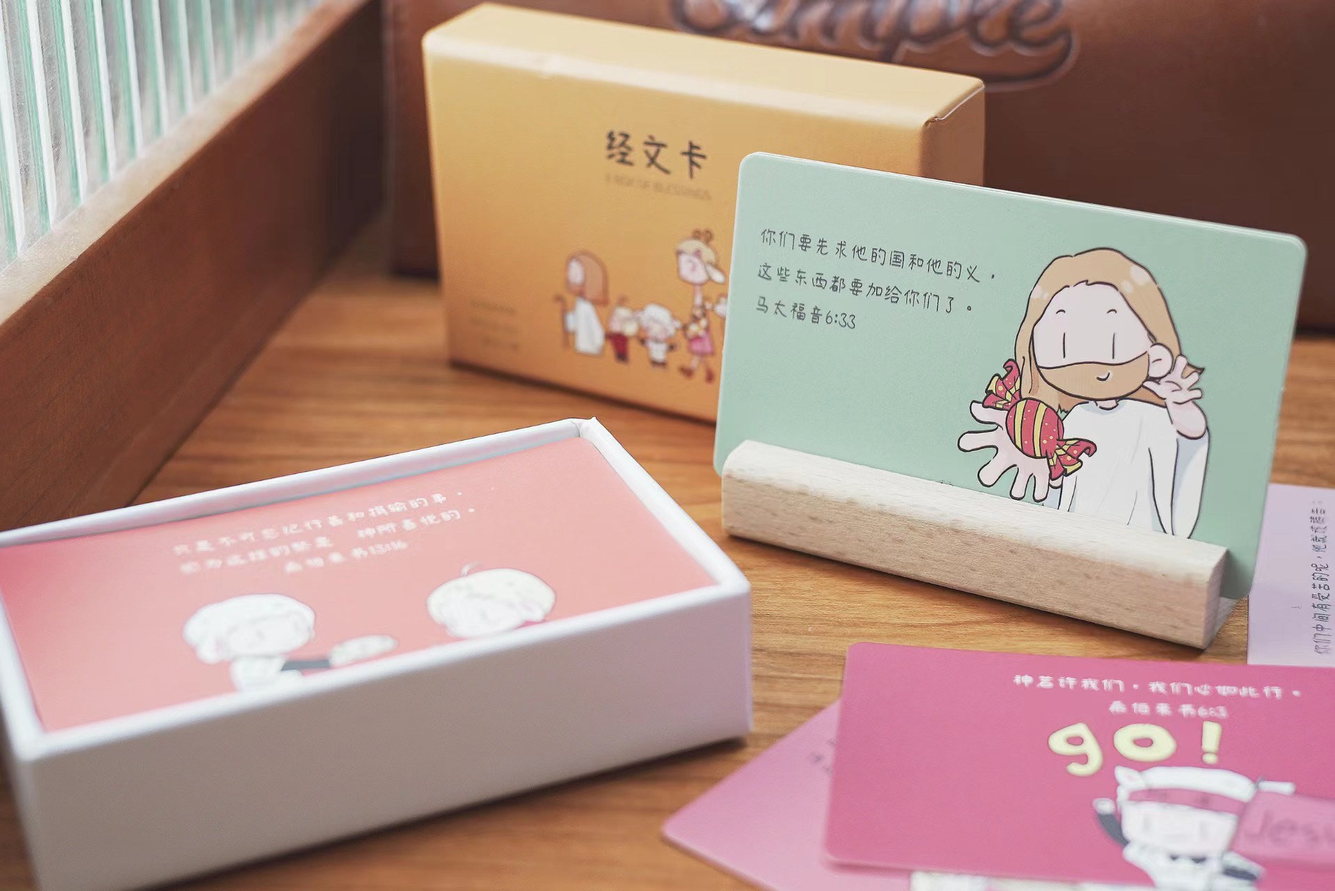 Set of mini Christian cards with Bible verses and illustrations displayed on a wooden surface