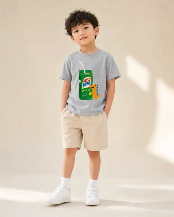 Young child wearing the grey Mylo Mine dinosaur drink packet kids’ T-shirt