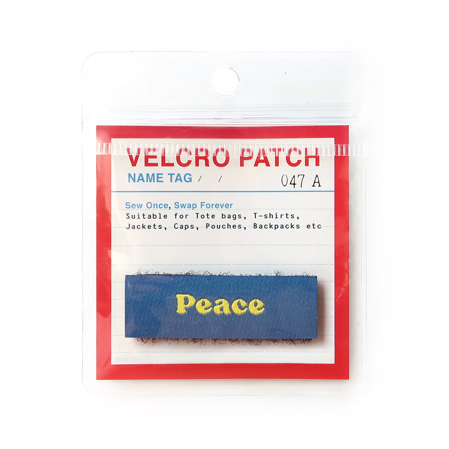 Blue Velcro tag with yellow text 'Peace,' an inspirational Christian embroidered patch for apparel and accessories
