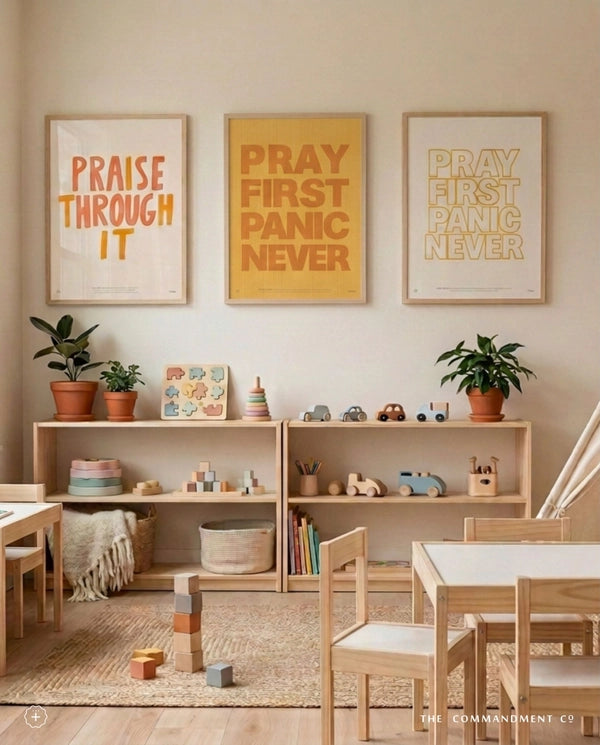 Pray First Panic Never outline Christian poster displayed with two coordinating faith posters above wooden shelves in a playroom