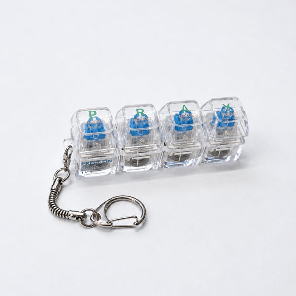 Clear PRAY light-up keycap keychain with four pressable keys
