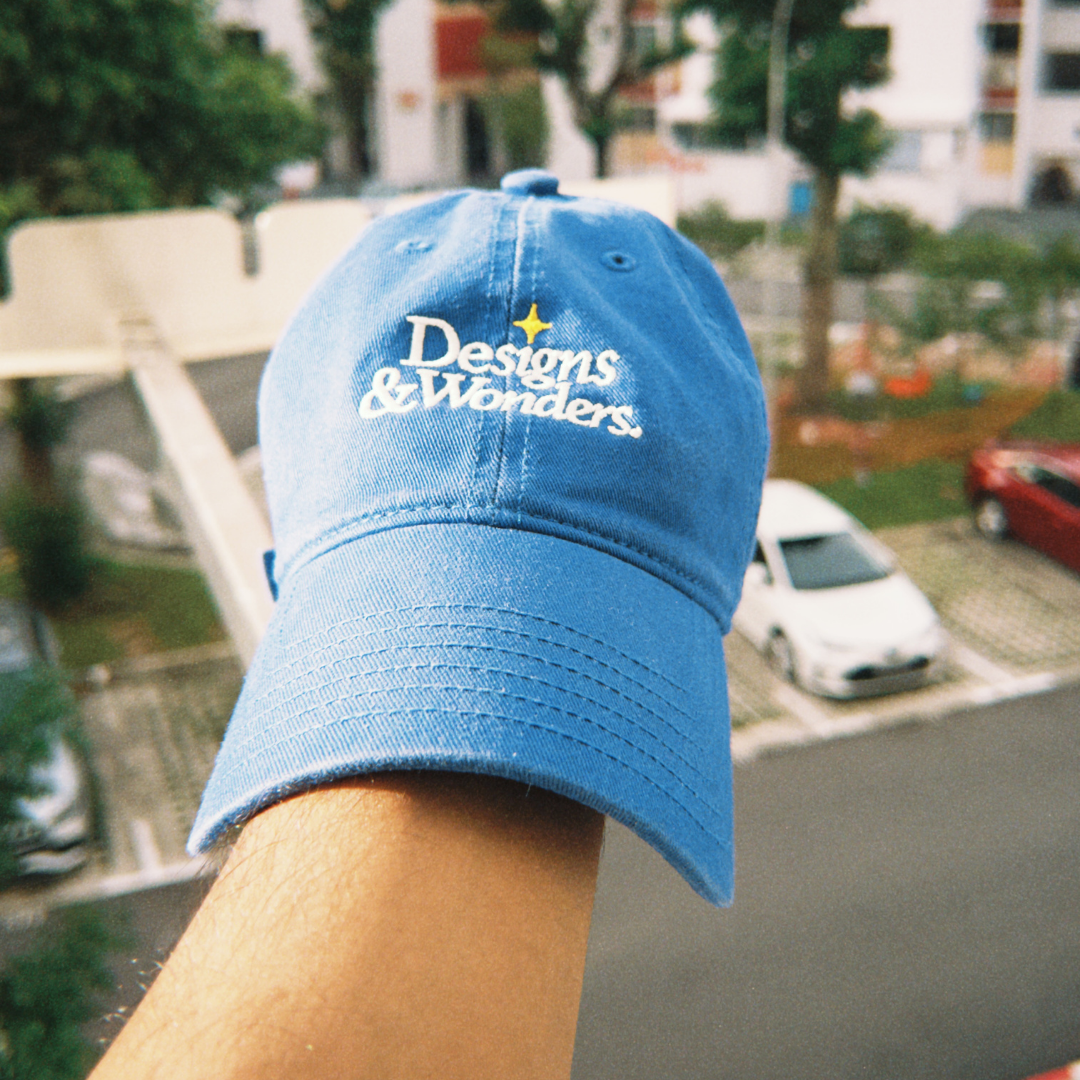 Designs & Wonders blue embroidered cap styled outdoors