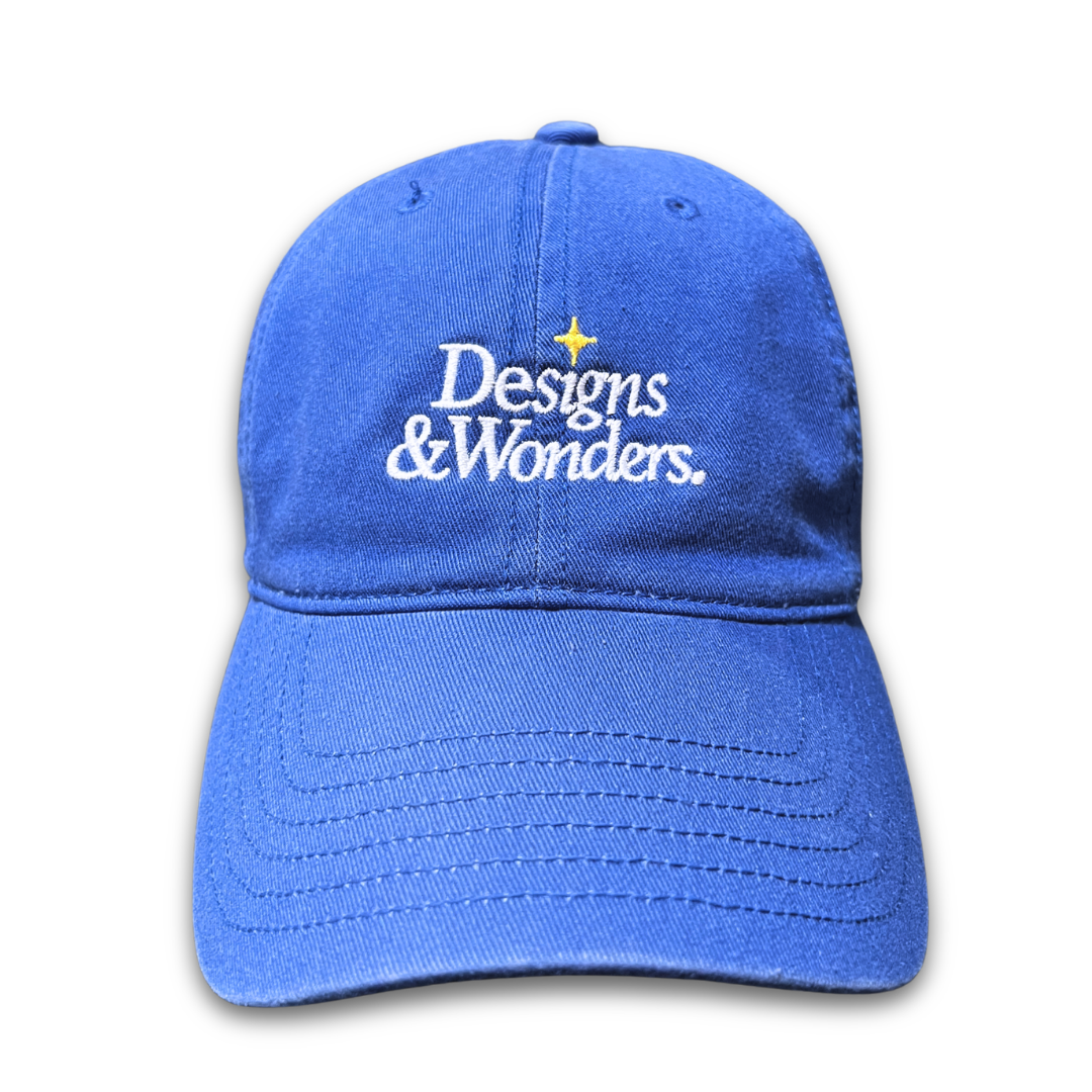 Designs & Wonders embroidered blue cap by Quite at Home with yellow sparkle detail