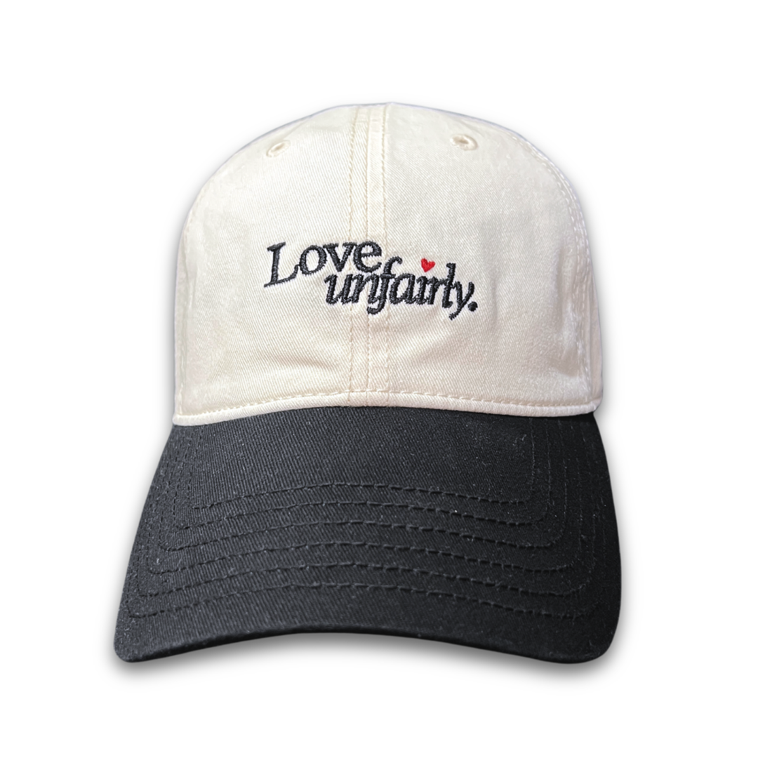 Love Unfairly embroidered cap by Quite at Home in cream and black