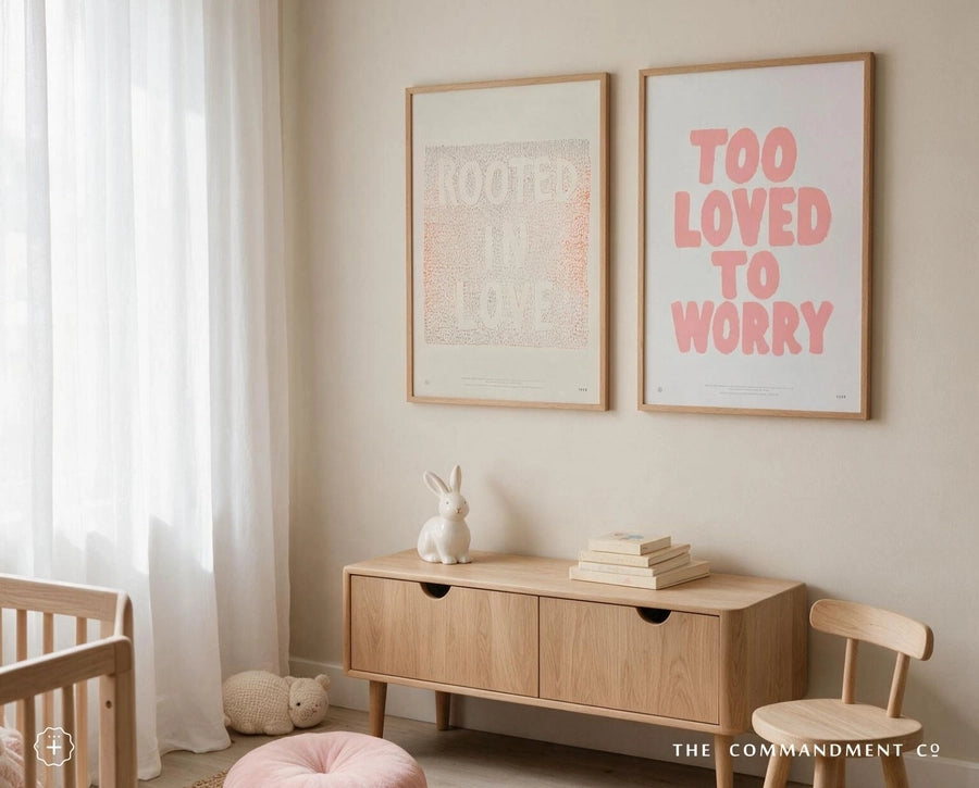 Rooted In Love Christian poster displayed beside a Too Loved To Worry poster in a soft neutral nursery