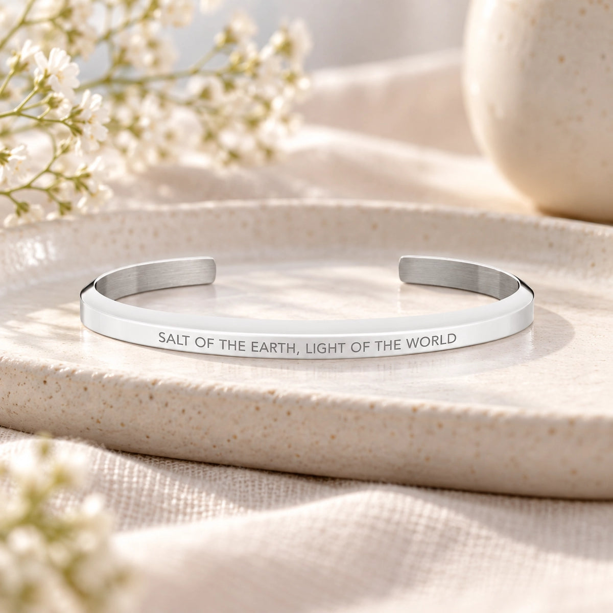 Salt of the Earth, Light of the World silver classic verse band styled on a ceramic tray.
