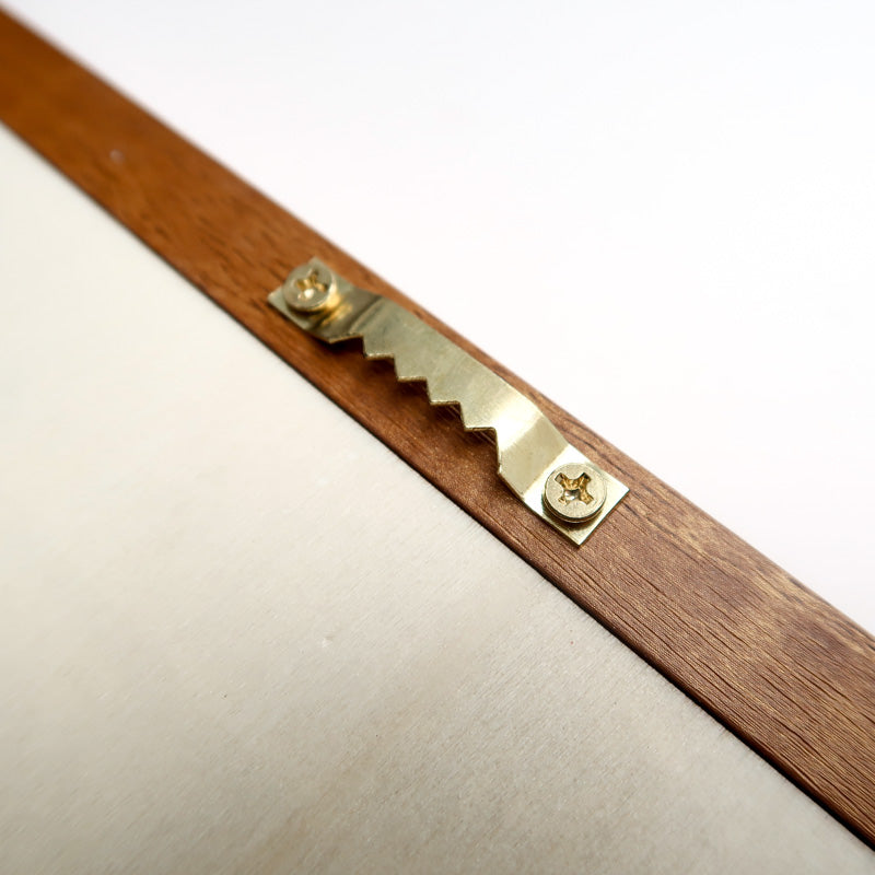 Close-up view of the back side of a wooden poster frame, showing a sturdy sawtooth hanger securely attached with screws, designed for easy wall mounting. Ideal for stable and elegant poster hanging solutions.