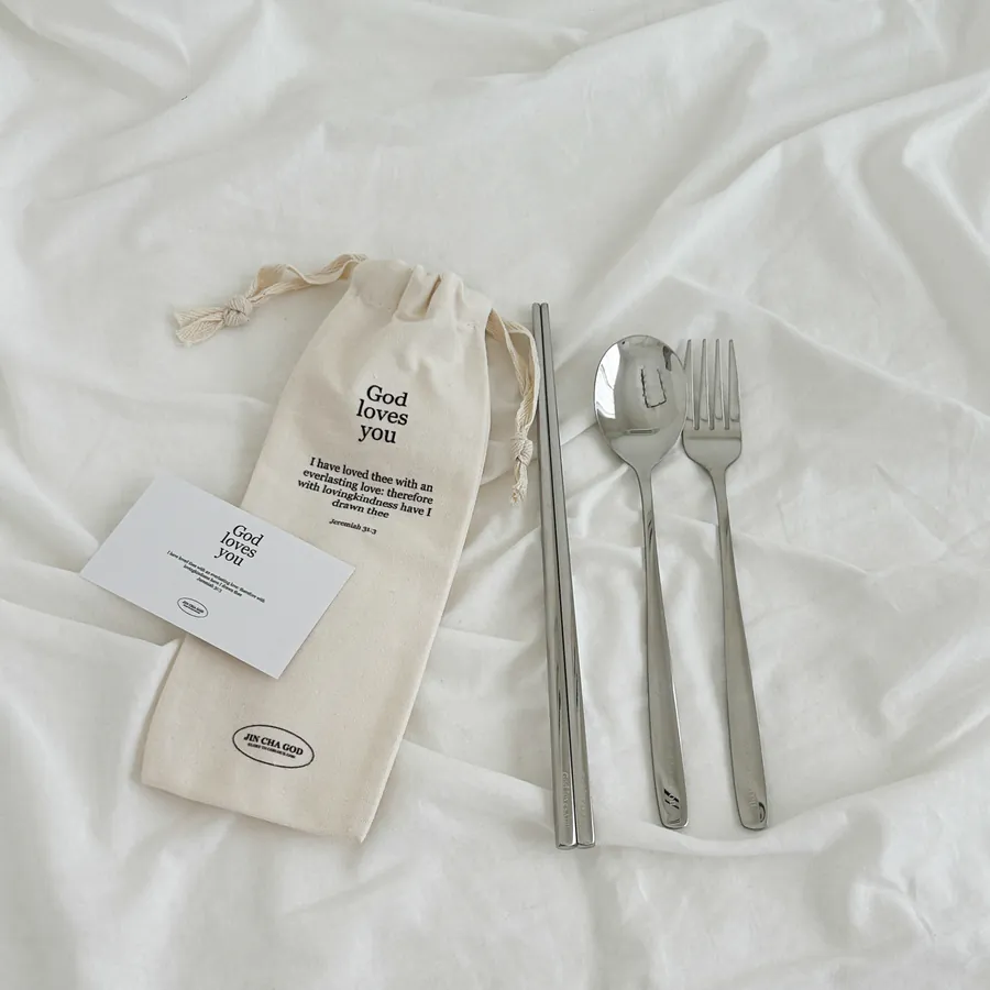 Stainless steel cutlery set including a spoon, fork, and chopsticks in a canvas pouch with the message "God loves you" and a Bible verse from Jeremiah 31:3.