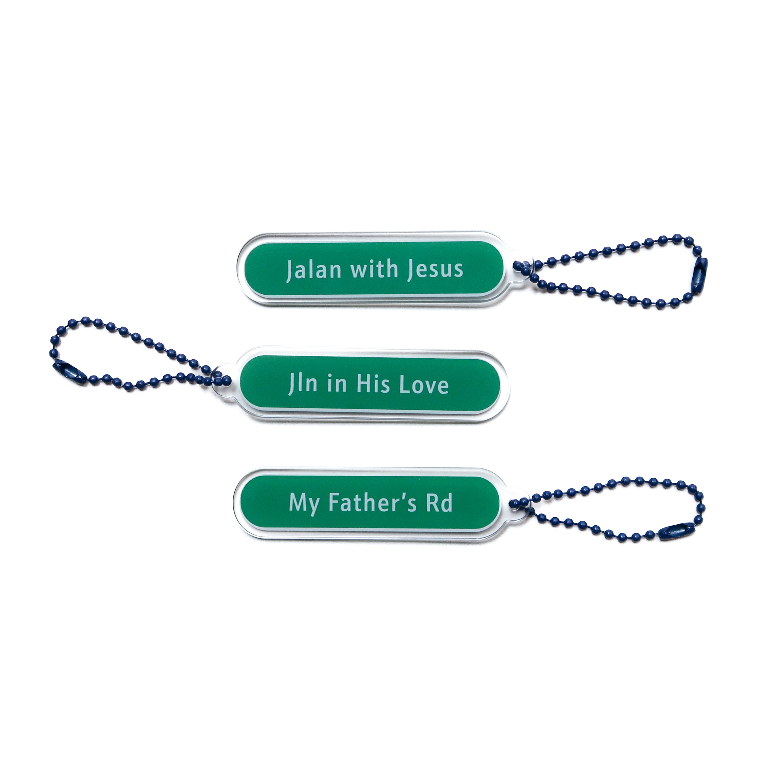Set of three acrylic keychains with "Jalan with Jesus," "Jln in His Love," and "My Father's Rd" designs, from The Commandment Co, Singapore.