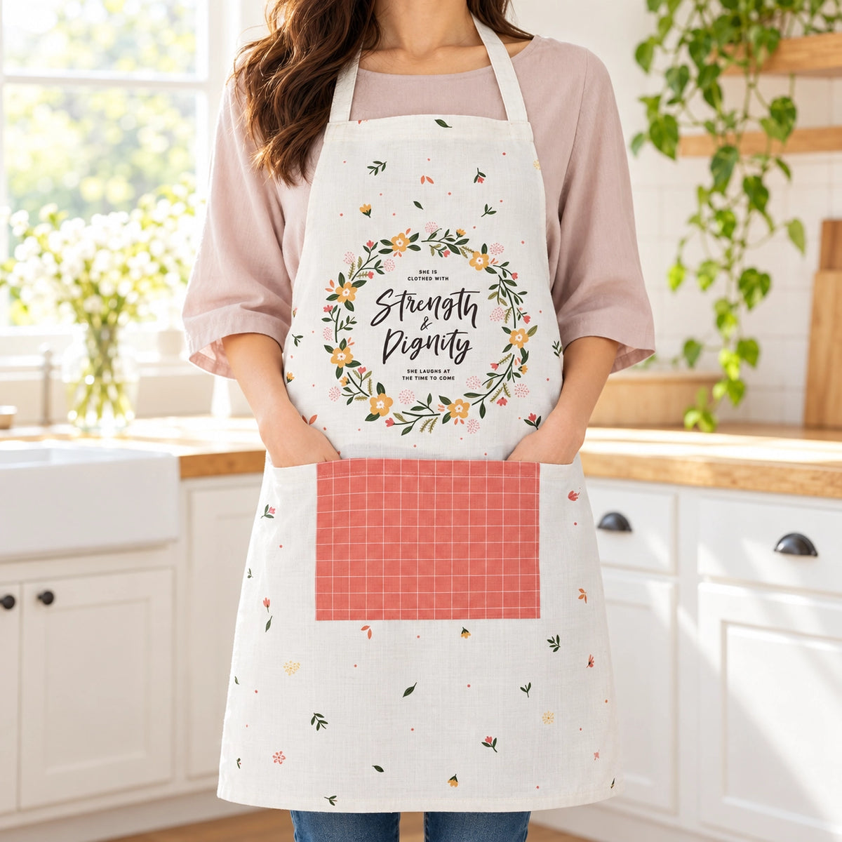 Strength and Dignity Christian apron worn in a bright home kitchen