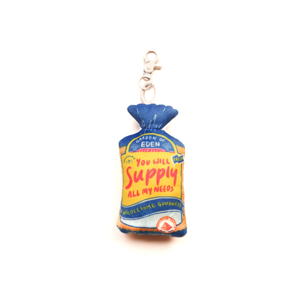 Supply Bread plushie keychain with bread packet-inspired design and “You will supply all my needs” detail.