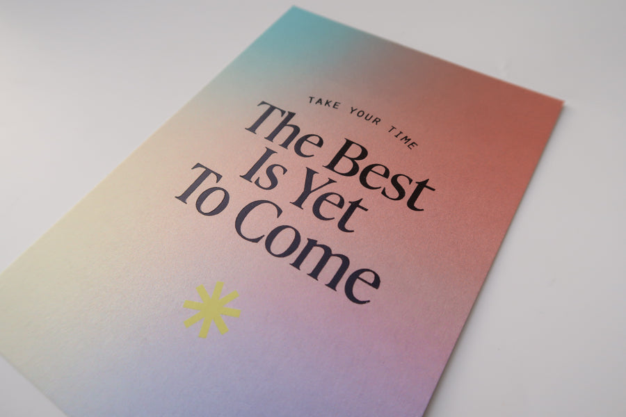 A detailed view of a postcard with a gradient background and the encouraging message "The Best Is Yet To Come," along with the phrase "Take Your Time," designed to inspire hope and positivity.