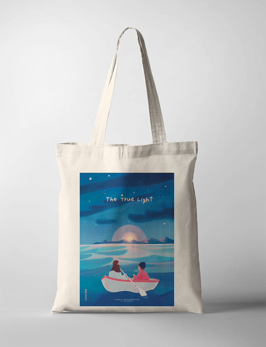 “The True Light” Christian tote bag featuring illustration of two people in a boat at sunset, faith-inspired canvas bag.