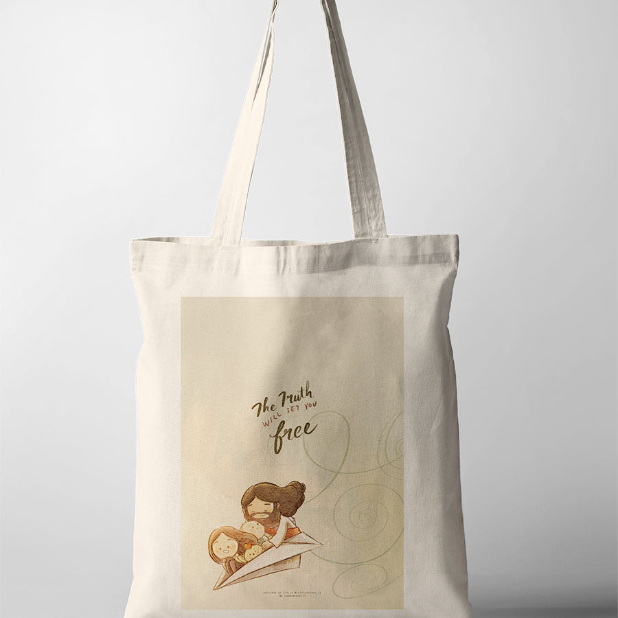 Christian tote bag showcasing Jesus with children on a paper airplane and the words “The truth will set you free,” from John 8:32.