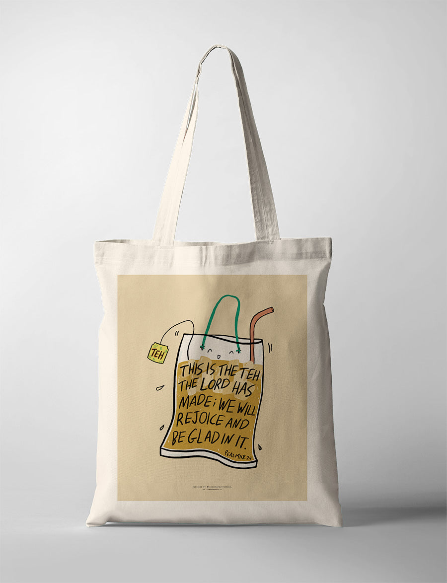 Inspirational tote bag with a faith message and drink packet, featuring the text 'This is the teh the Lord has made; we will rejoice and be glad in it'