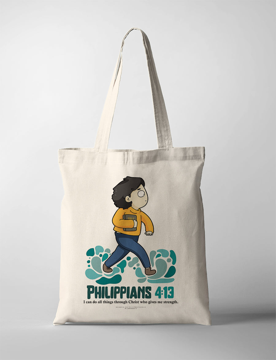 Christian tote bag collaboration between John Euclid and The Commandment Co featuring illustrated character walking on waves while holding a Bible with the verse Philippians 4:13 about strength through Christ
